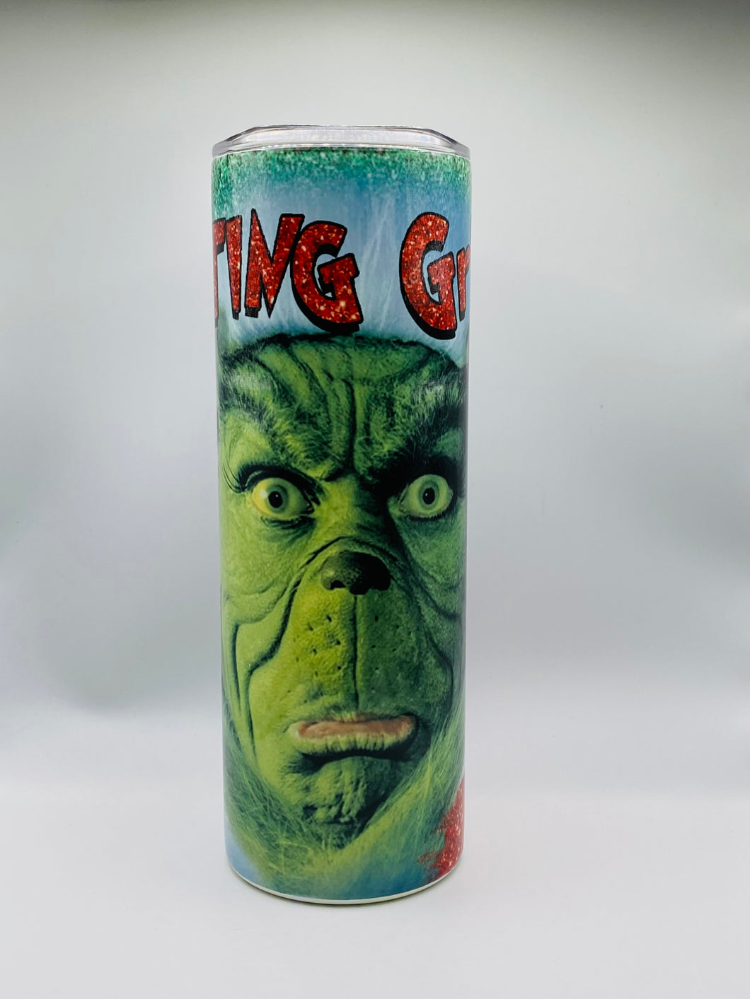 Rested Grinch Face 20 oz skinny Tumbler with lid and straw.